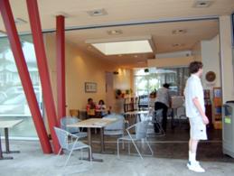 looking into the Tex Pahala Drive In Restaurant dining area from the sidewalk